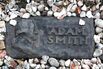 A marker leads the way to the grave of economist Adam Smith