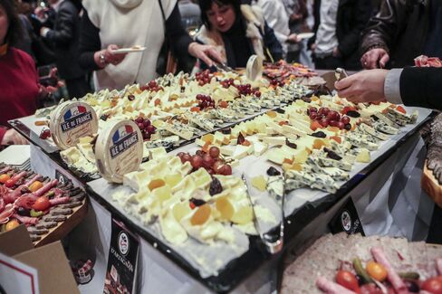 Platters of cheese, fruit, meat, and paté were set for decimation.