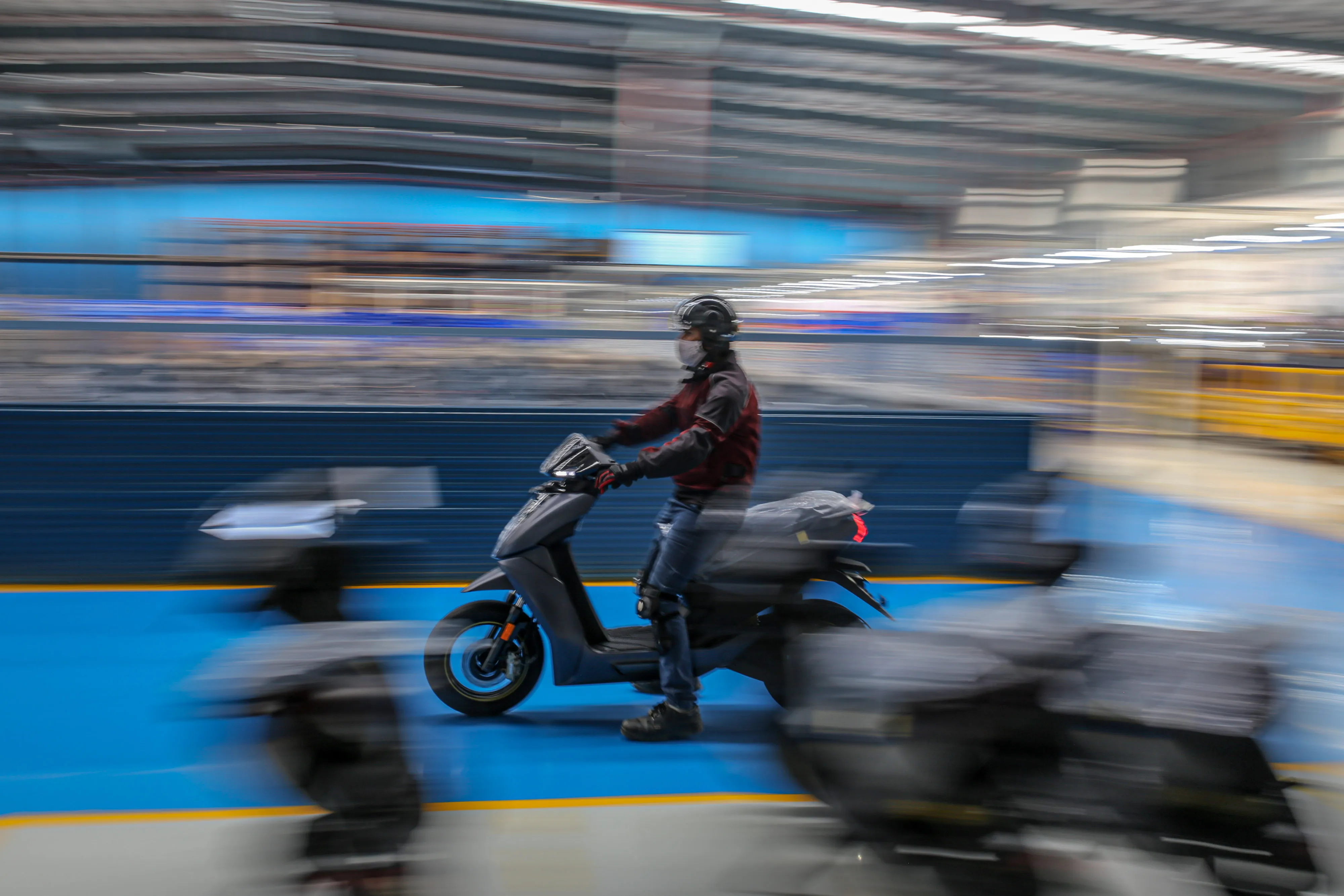 An employee test drives an Ather Energy electric scooter.
