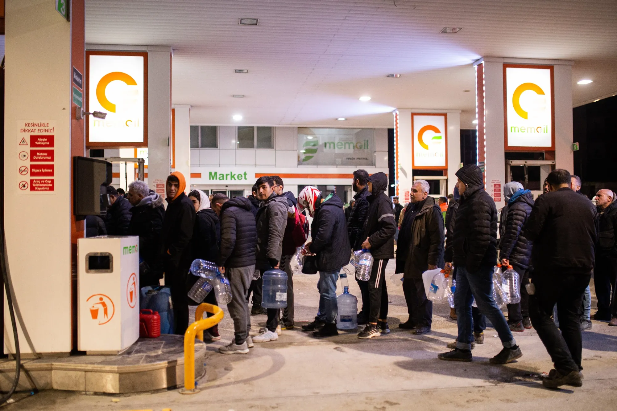 Residents queue to fill containers with gasoline at a gas station amid scarce supplies after earthquakes,&nbsp;in Hatay, in February.&nbsp;