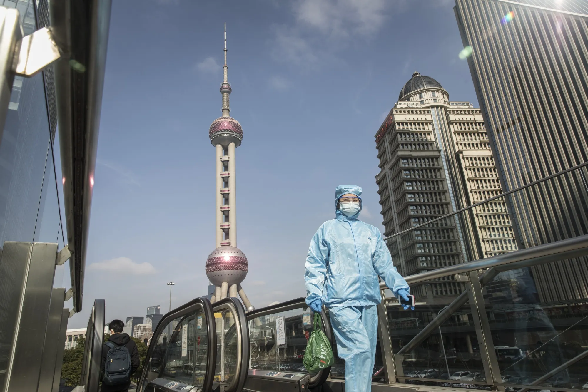 A pedestrian wearing a protective suit walks through Shanghai on Feb. 27.