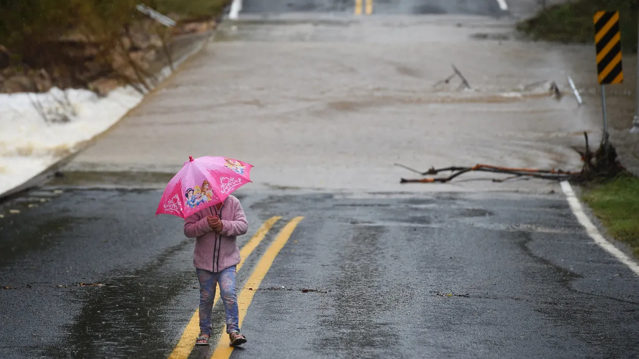 A girl walks near a flooded street in Austin, Texas, on October 24, 2015.
