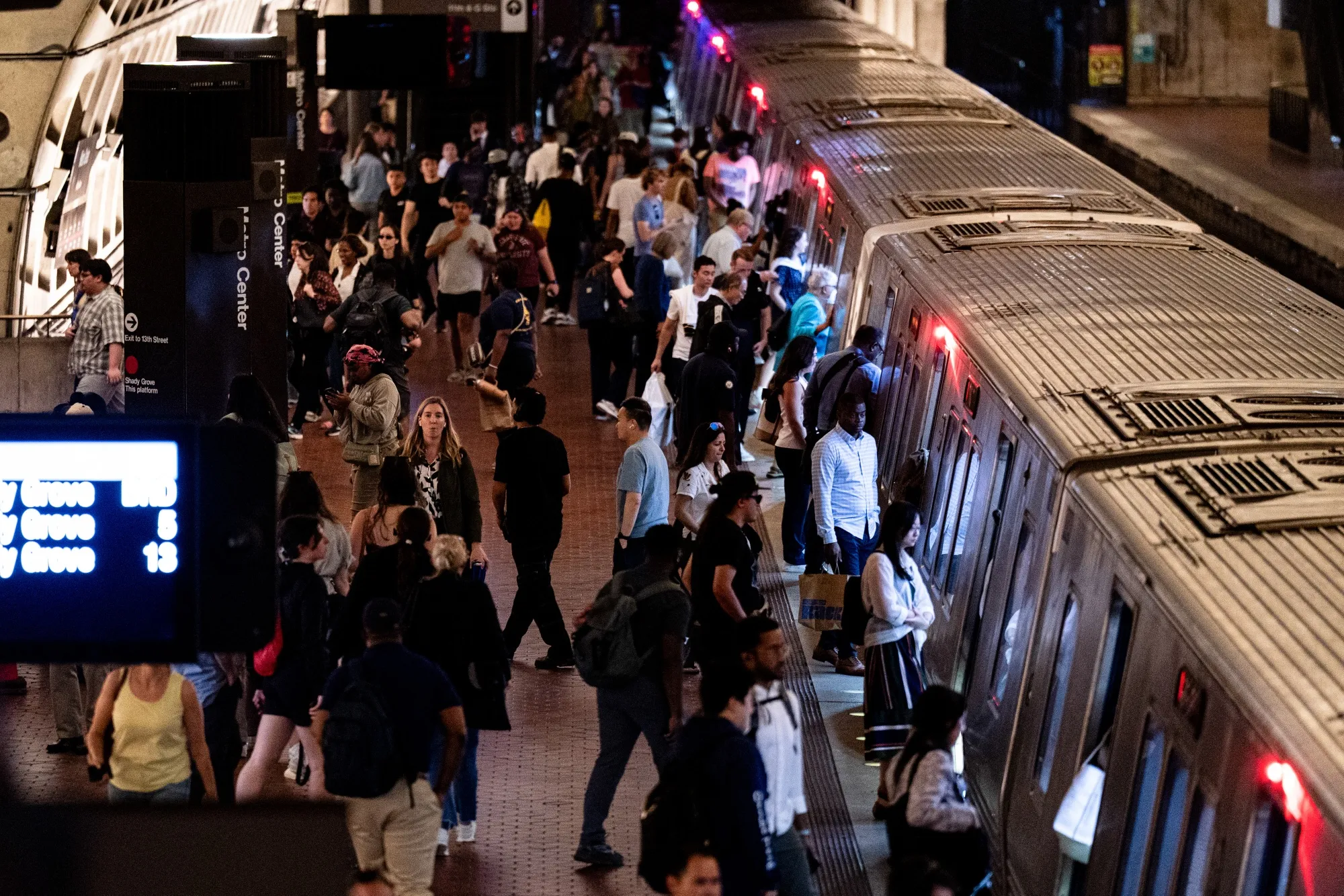 Commuters board a Red line Metro train at the Metro Center metro stop in Washington, DC.