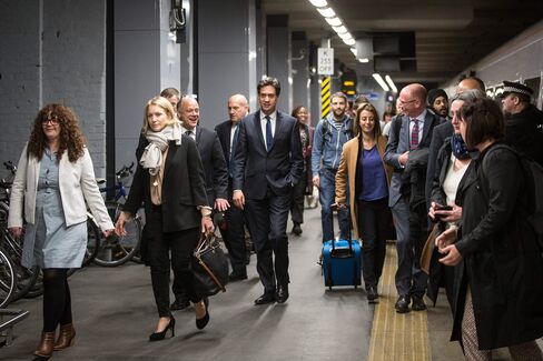 Labour Leader Ed Miliband with members of his media team and their security detail arrive at King's Cross railway station in London, on April 23, 2015.