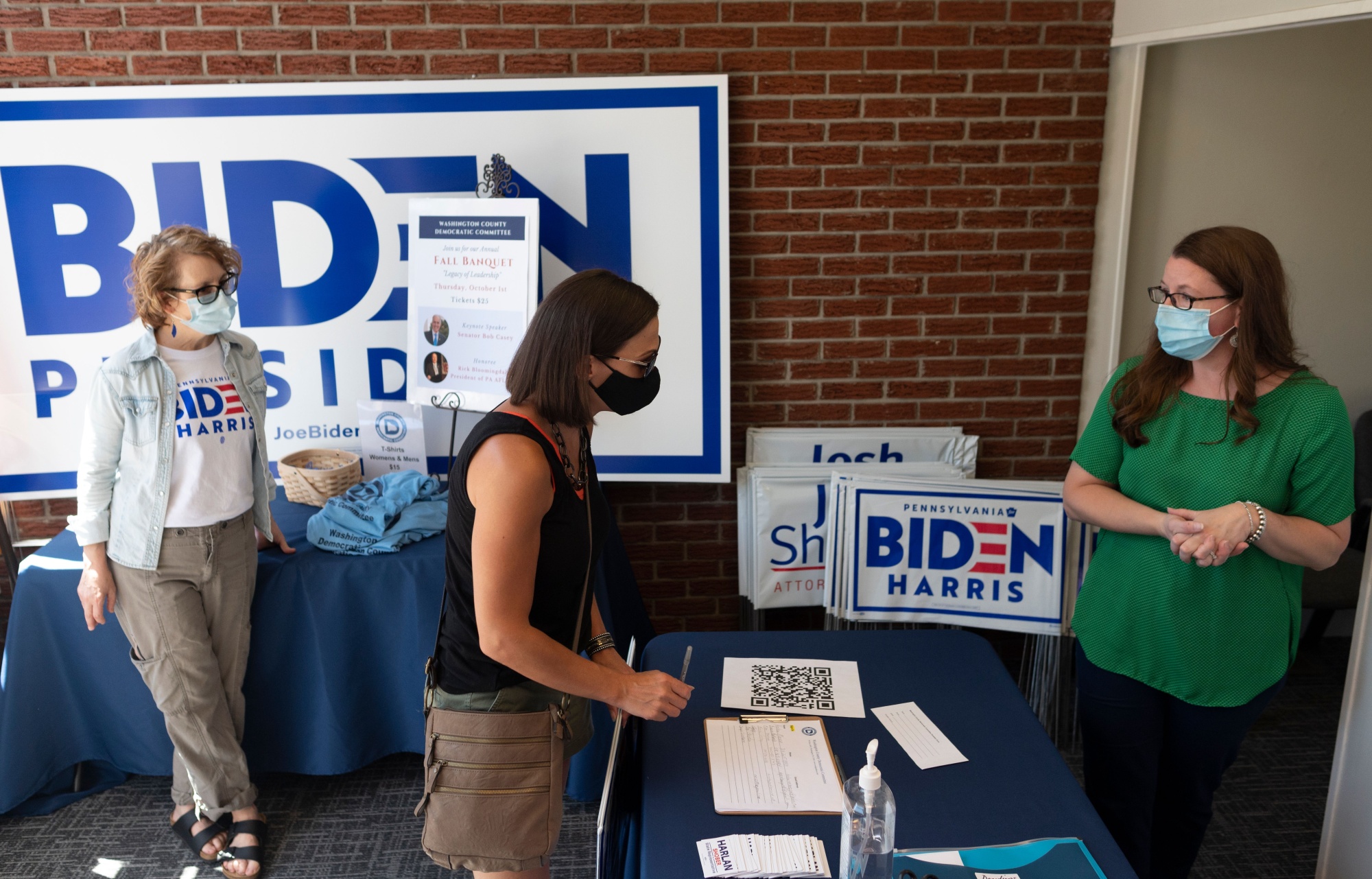 A woman signs up for a mailing list in Pennsylvania’s Washington County Democratic office before taking a yard sign for presidential candidate Joe Biden.&nbsp;
