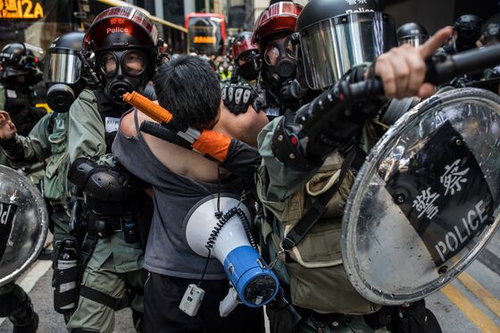 Hong Kong Violence Escalates With Bullets, Tear Gas, Man on Fire