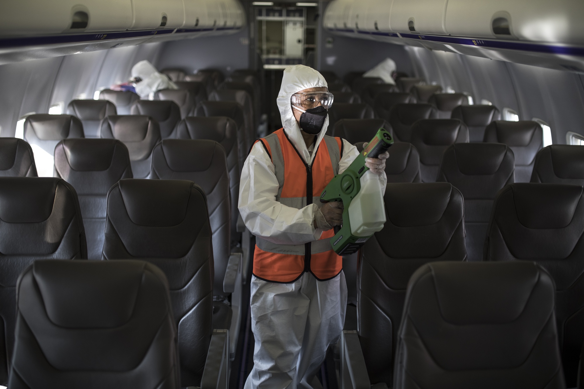 Workers disinfect a plane before flights resumed&nbsp;in Bogota, Colombia.&nbsp;