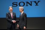 Kazuo Hirai, incoming chairman of Sony Corp., left, and Kenichiro Yoshida, incoming chief executive officer, shake hands while posing for photographs during a news conference in Tokyo, Japan.