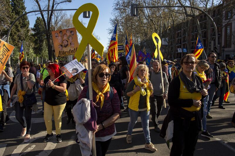 Demonstrators carry Catalan Independence flags and yellow ribbons in Madrid March 16, 2019.