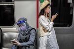 Commuters wearing face masks as a preventive measure on a train in Hong Kong.