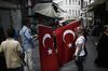 A street vendor sells Turkish flags to tourists in the Sultanahmet district of Istanbul, Turkey, on Thursday, Aug. 3, 2017. Turkey’s central bank raised its inflation forecast for this year on higher food prices, and reiterated its policy not to loosen monetary conditions until the outlook improves.