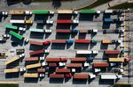 Trucks transport cargo containers at the Port of Baltimore.