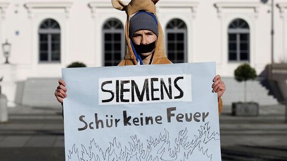 Siemens CEO Faces Down Protesters, Signals Tough Year Ahead