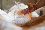 A farmer handles fertilizer stored in a warehouse near Brasilia.