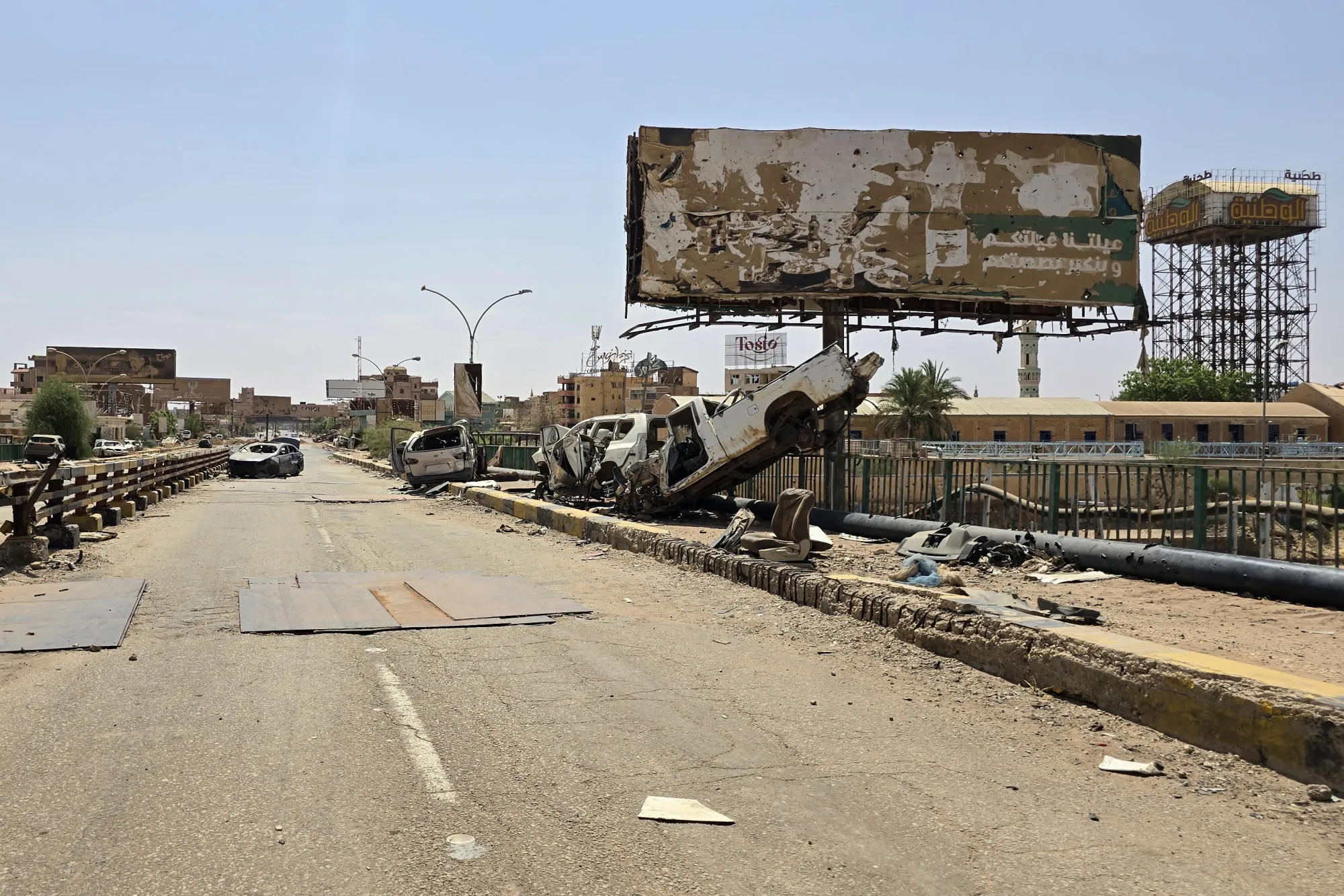 Destroyed cars on the remains of the Shambat Bridge&nbsp;connecting&nbsp;Omdurman and Bahri, on June 24.