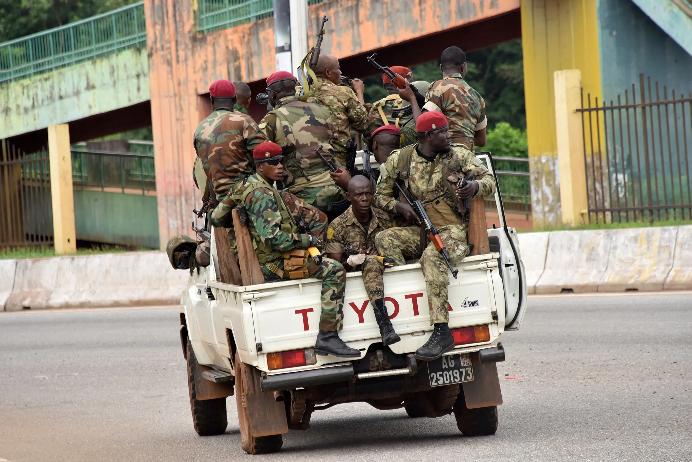 Members of the Armed Forces of Guinea drive through the central neighborhood of Kaloum.