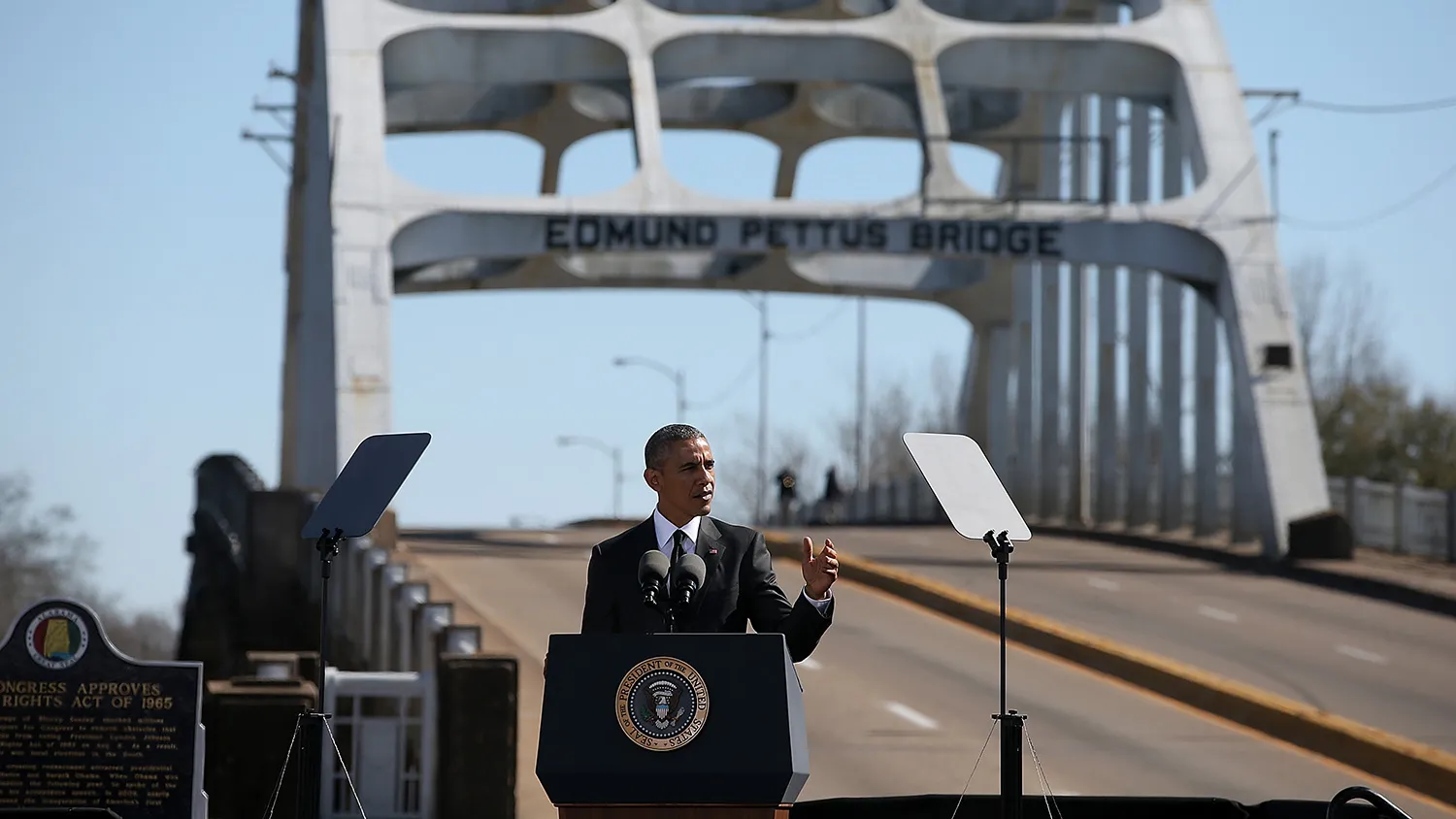 SELMA, AL - MARCH 07: U.S. president Barack Obama speaks in front of the Edmund Pettus Bridge on March 7, 2015 in Selma, Alabama. Selma is commemorating the 50th anniversary of the famed civil rights march from Selma to Montgomery that resulted in a violent confrontation with Selma police and State Troopers on the Edmund Pettus Bridge on March 7, 1965.
