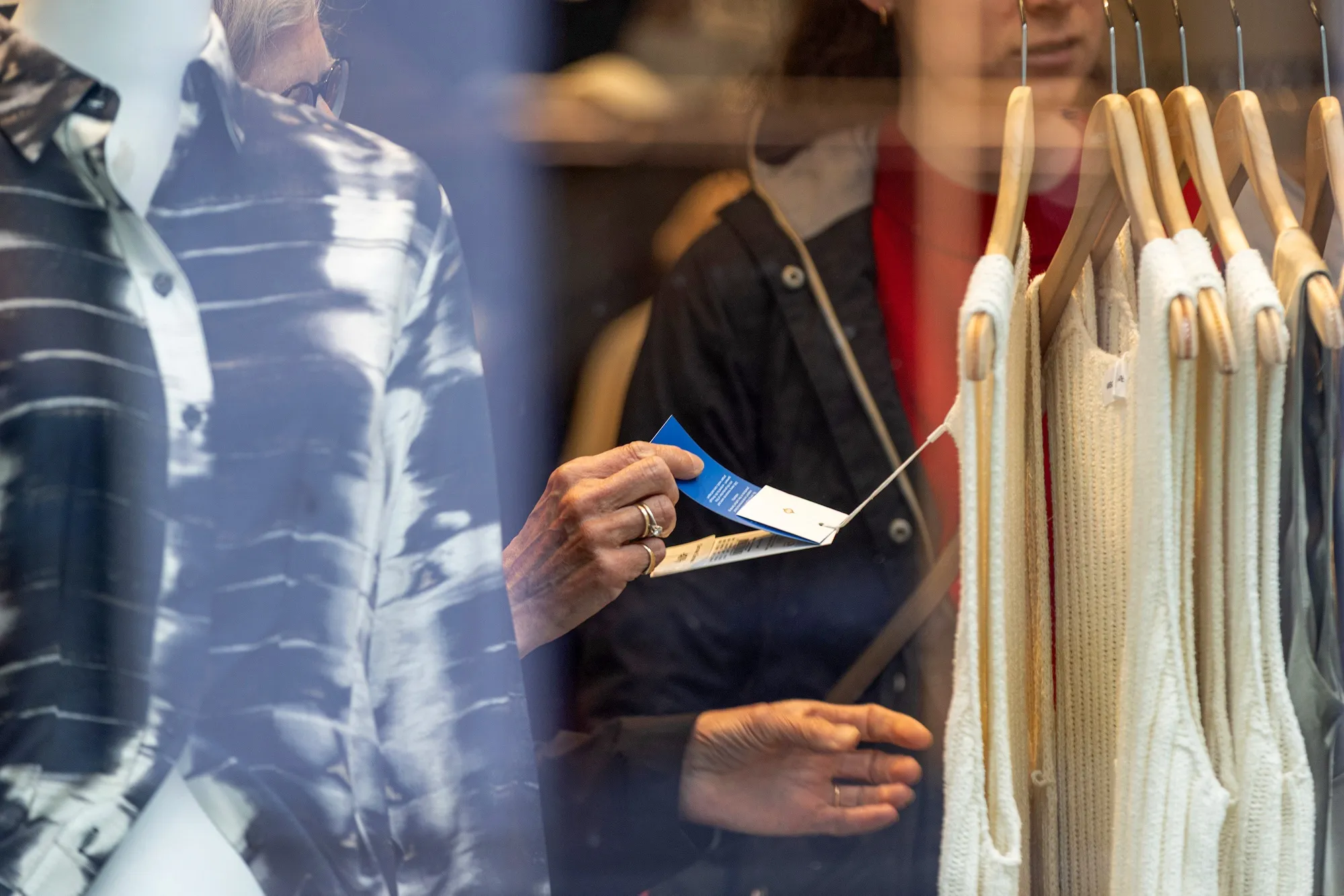 A shopper reads the clothing tag in a store in Oslo, Norway.