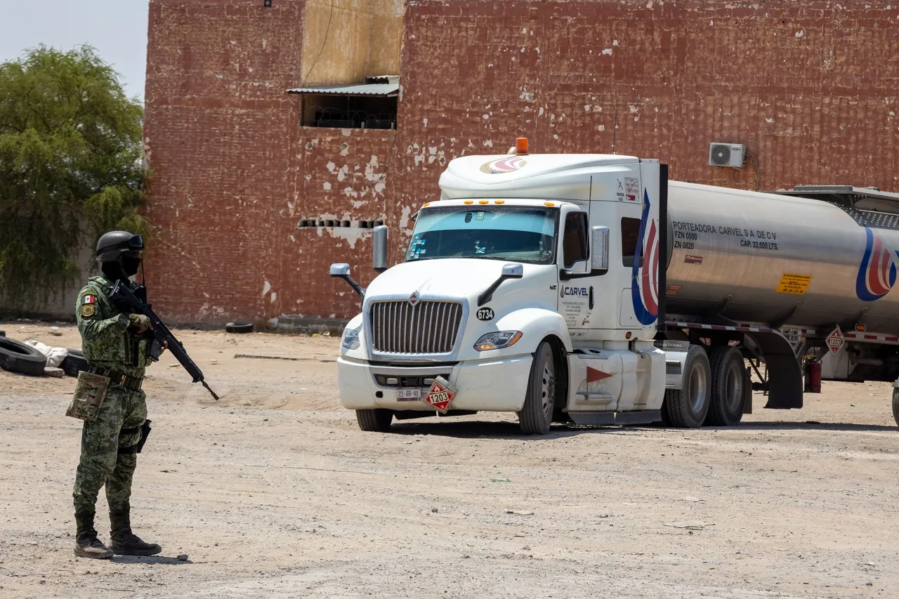 Members of the National Guard and the Army arrest a man allegedly involved in gasoline trafficking in Ciudad Juarez, Chihuahua, Mexico.