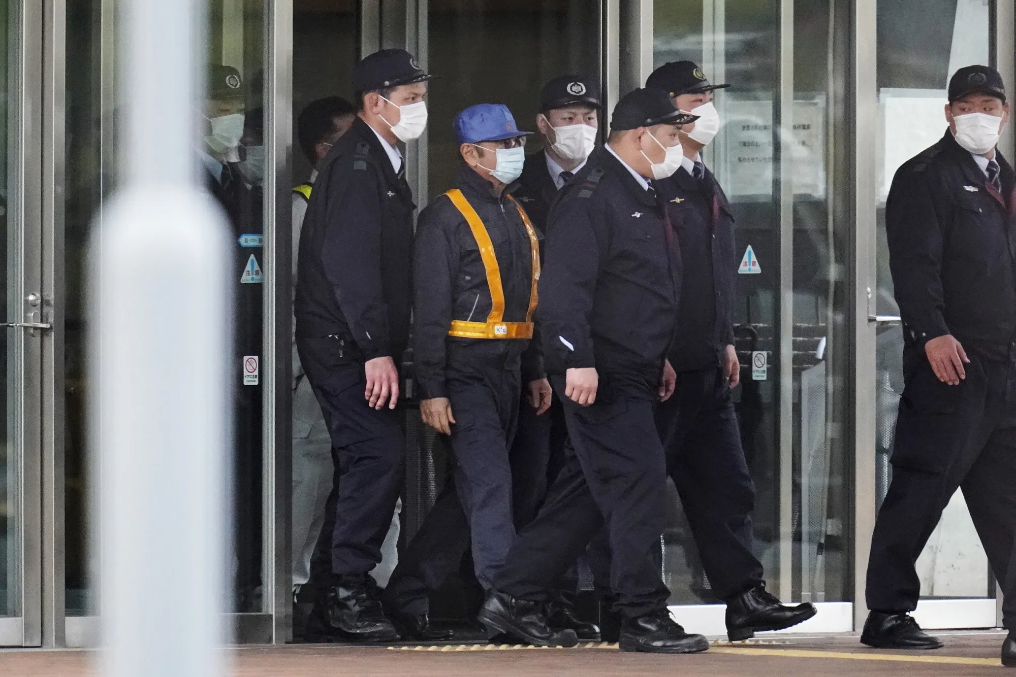Carlos Ghosn is escorted from Tokyo Detention House following his release on bail in March 2019.
