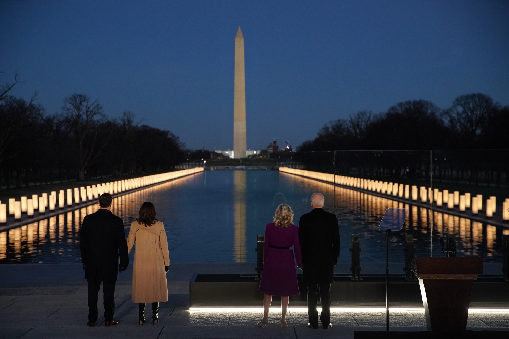 U.S. President-elect Joe Biden, from right, wife Jill Biden, U.S. Vice President-elect Kamala Harris, and husband Douglas Emhoff stand at the Lincoln Memorial Reflecting Pool during a Covid-19 memorial to lives lost in Washington, D.C.,on&nbsp;Jan. 19.&nbsp;