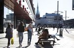 People walk on a busy shopping street in Stockholm, on May 22.