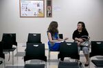 Health navigator Rebecca Wener (left) talking to a patient about health insurance exchanges at a Community Clinic health center in Silver Spring, Md.