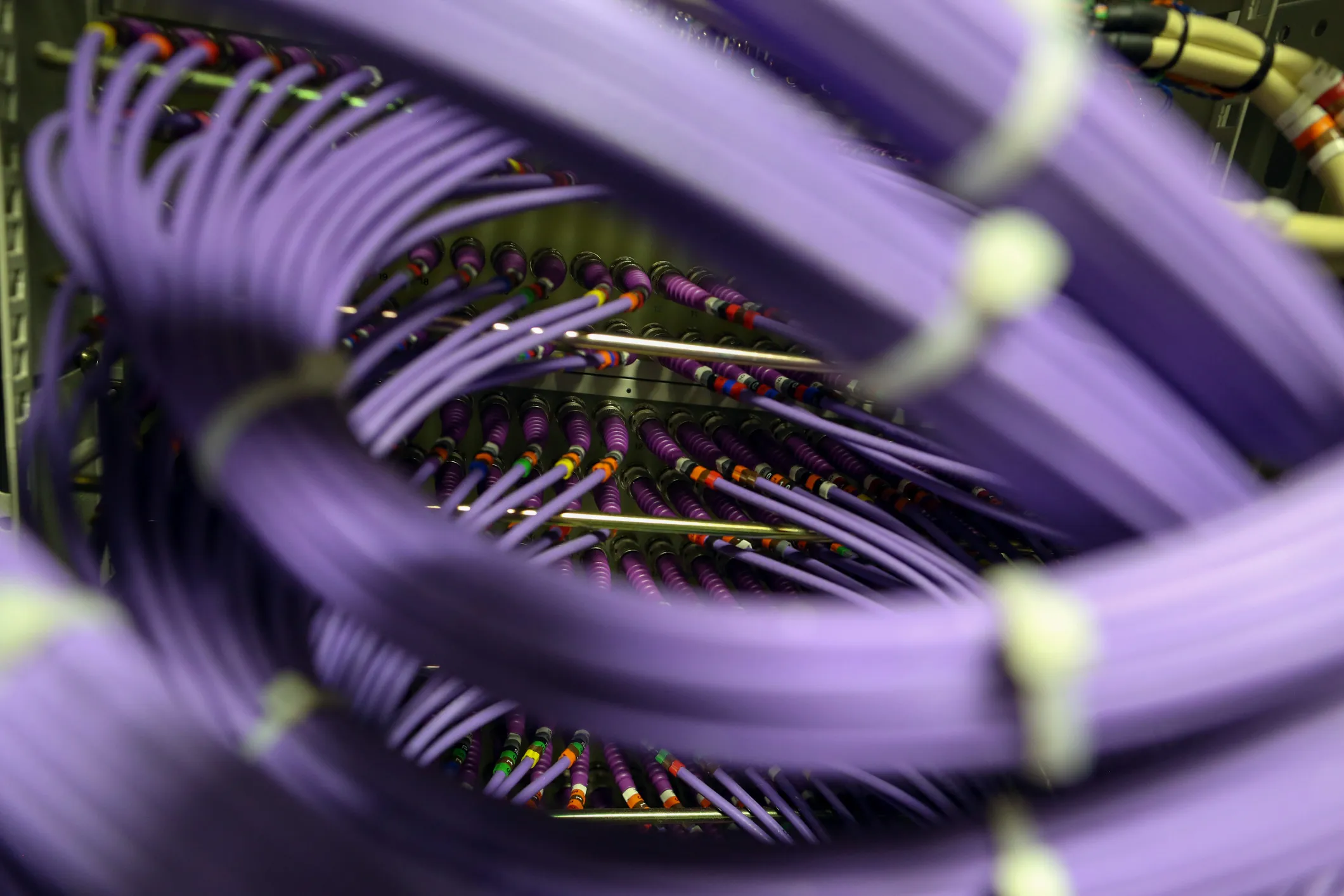 Coaxial cables feed into a server inside a comms room at an office in London, U.K., on Friday, Oct. 16, 2015. A group of Russian hackers infiltrated the servers of Dow Jones & Co., owner of the Wall Street Journal and several other news publications, and stole information to trade on before it became public, according to four people familiar with the matter.