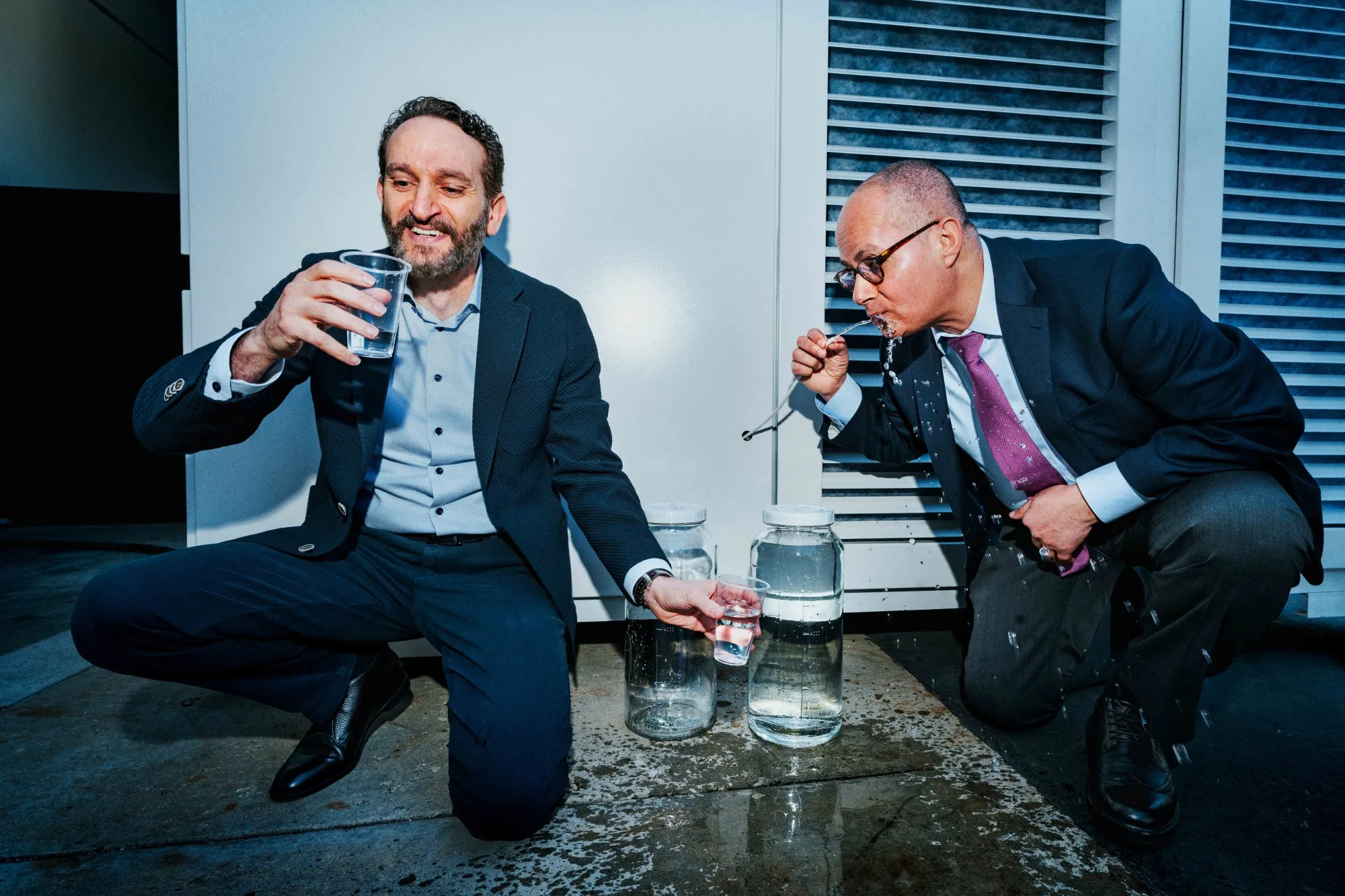Atoco CEO Samer Taha, left, and Atoco founder Omar Yaghi drink from the company’s water harvester prototype. Photographer: Ethan Noah Roy/Bloomberg