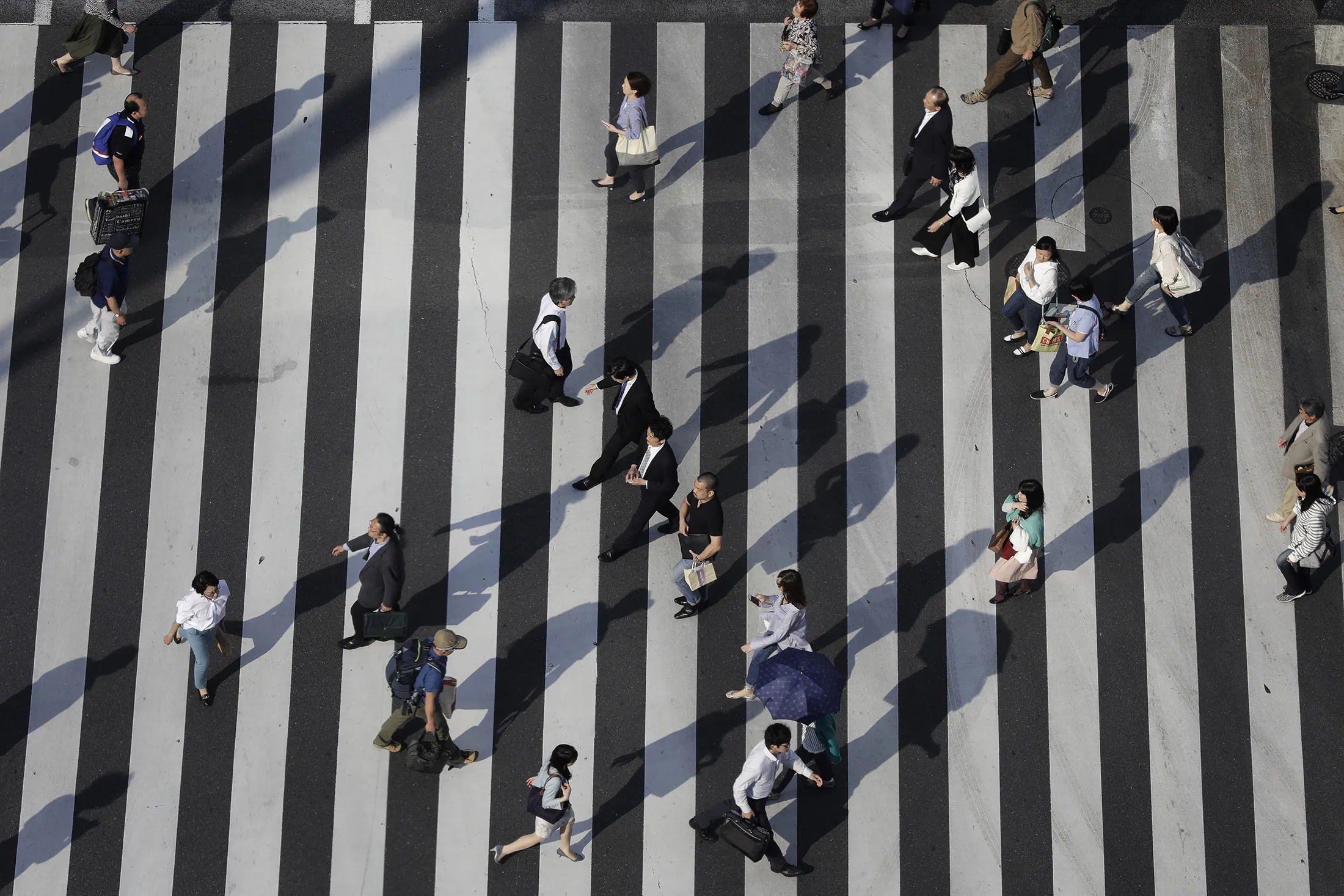 Pedestrians cross an intersection in Tokyo, Japan.