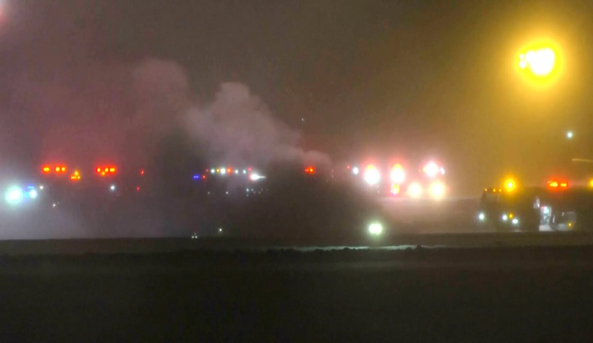 Emergency services work on a scene of a plane crash at the Bangor Airport in Maine&nbsp;in an image taken from video provided by WABI television on&nbsp;Jan. 25.