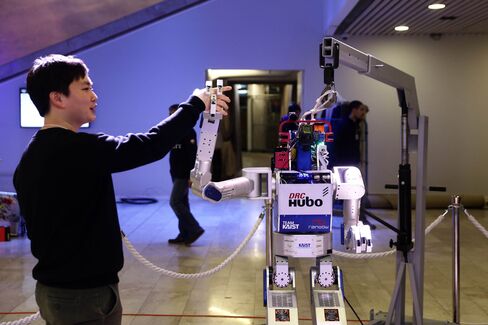 A technician demonstrates the Hubo robot in the Congress Center conference hall in preparation for the start of the World Economic Forum (WEF) in Davos.