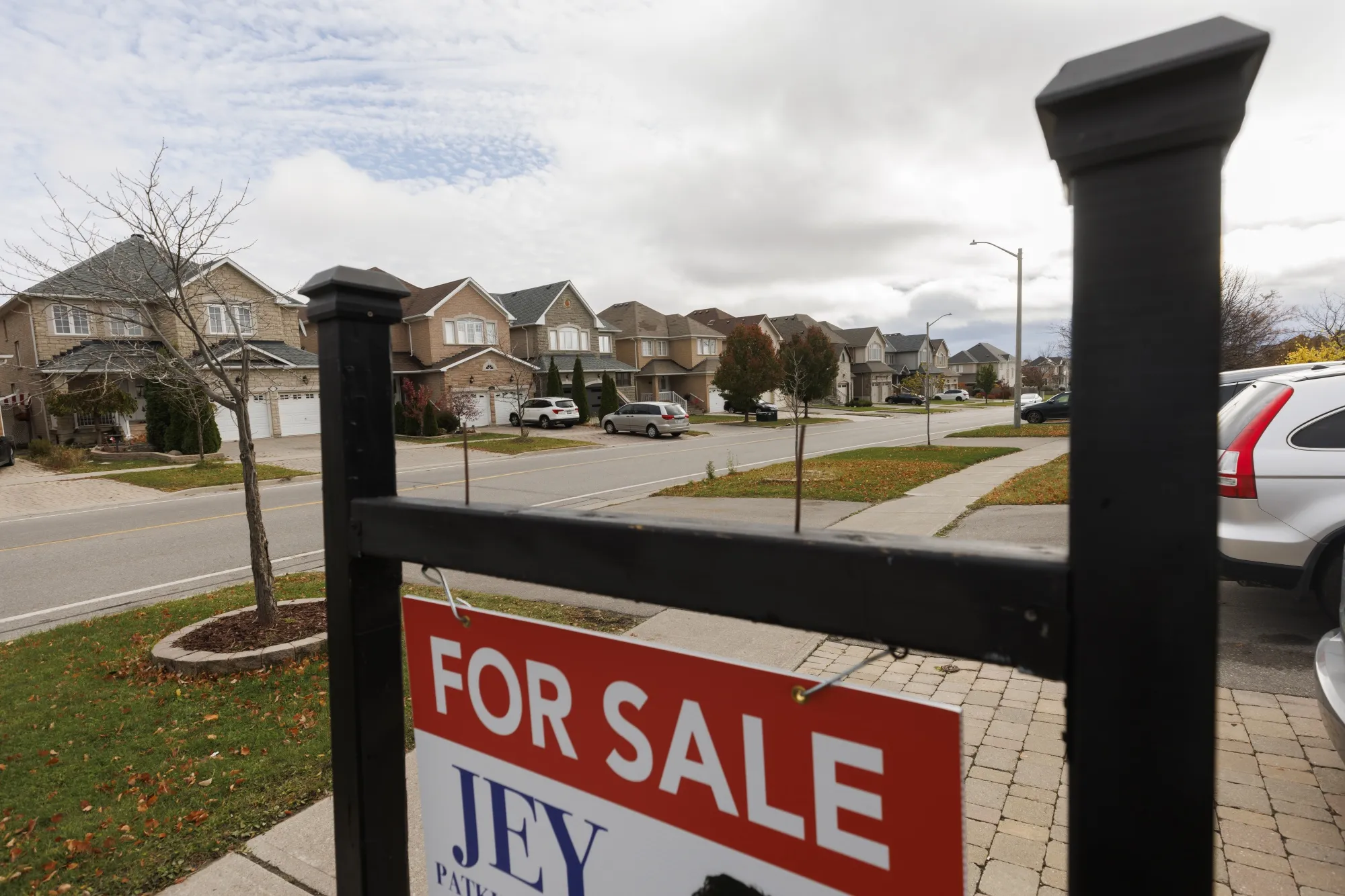 A "For Sale" sign in front of a home in Richmond Hill, Ontario.