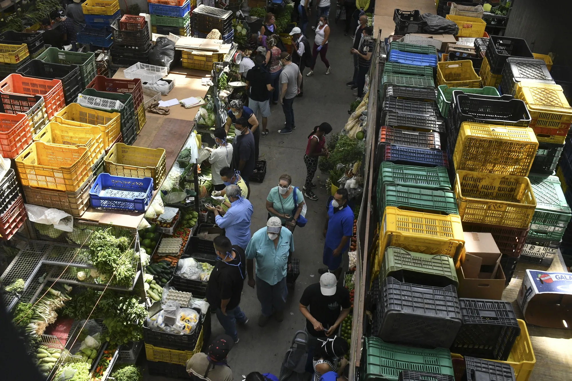 Shoppers wear protective face masks at the municipal market in the Chacao neighborhood of Caracas, Venezuela.