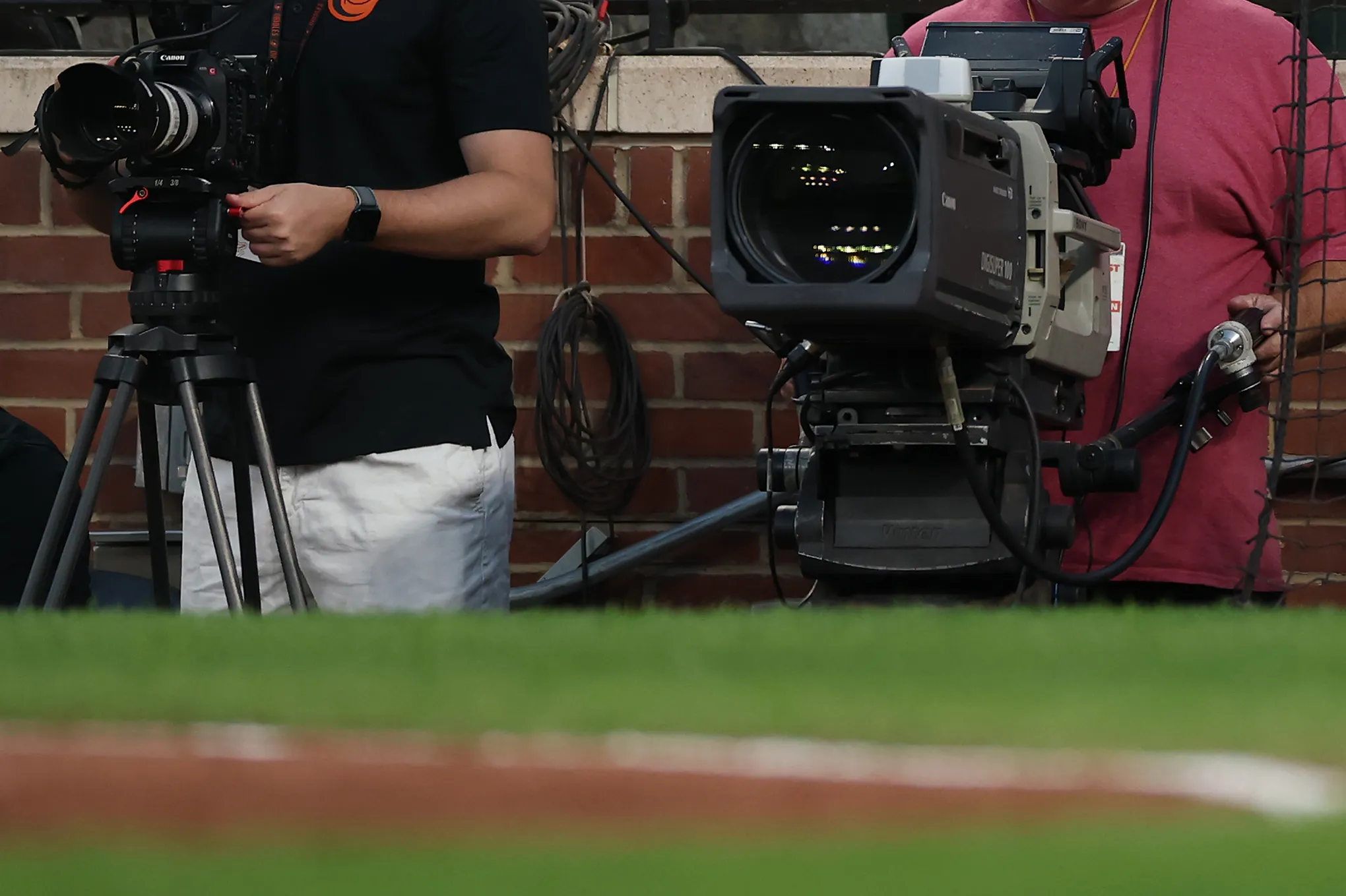 A broadcast camera operator at a MLB game.