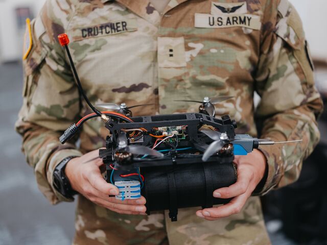 A technician holds a Kestrel drone with an explosive attached to it at Lighting Labs at Schofield Barracks in Honolulu.