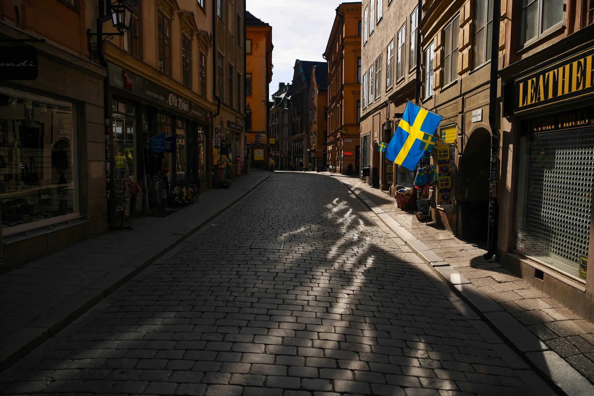 Swedish flags fly from a tourist souvenir shop in Gamla Stan in Stockholm, Sweden.