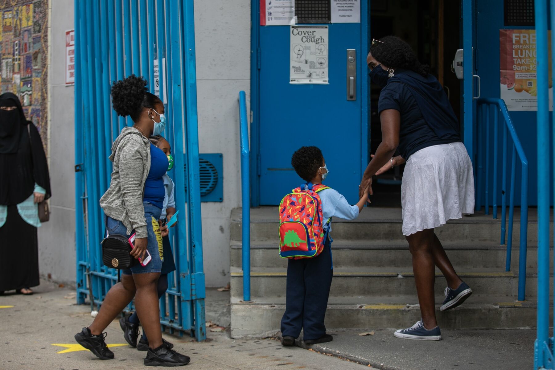 A student wearing a protetctive mask enters PS 15 Roberto Clemente School in New York, U.S., on Tuesday, Sep. 29, 2020. 