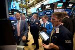 Traders work on the floor of the New York Stock Exchange (NYSE) in New York, U.S,