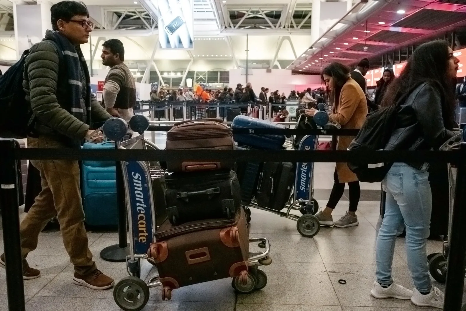 Travelers wait to check-in at a Delta counter in Terminal 4 at John F. Kennedy International Airport in Dec.&nbsp;