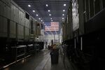 An American flag hangs as General Electric Co. (GE) Evolution Series Tier 4 diesel locomotives stand on the final assembly line at the GE Manufacturing Solutions facility in Fort Worth, Texas.