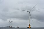 Barges position offshore floating wind turbines during assembly in the Hywind pilot park, operated by Statoil ASA, in Stord, Norway.