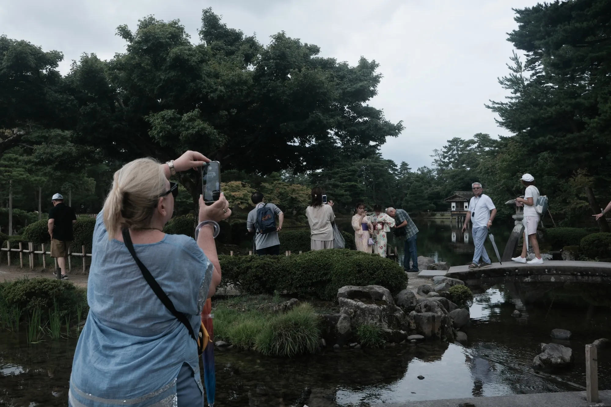 A visitor takes a photograph at Kenrokuen Garden in Kanazawa.