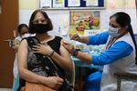 A member of the public receives a dose of the Covid-19 Covaxin vaccine at a vaccination center set up at a Delhi government health dispensary in New Delhi, India, on Thursday, Oct. 21, 2021.