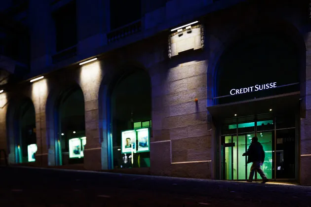 The entrance of a Credit Suisse bank branch at night in Lausanne, Switzerland