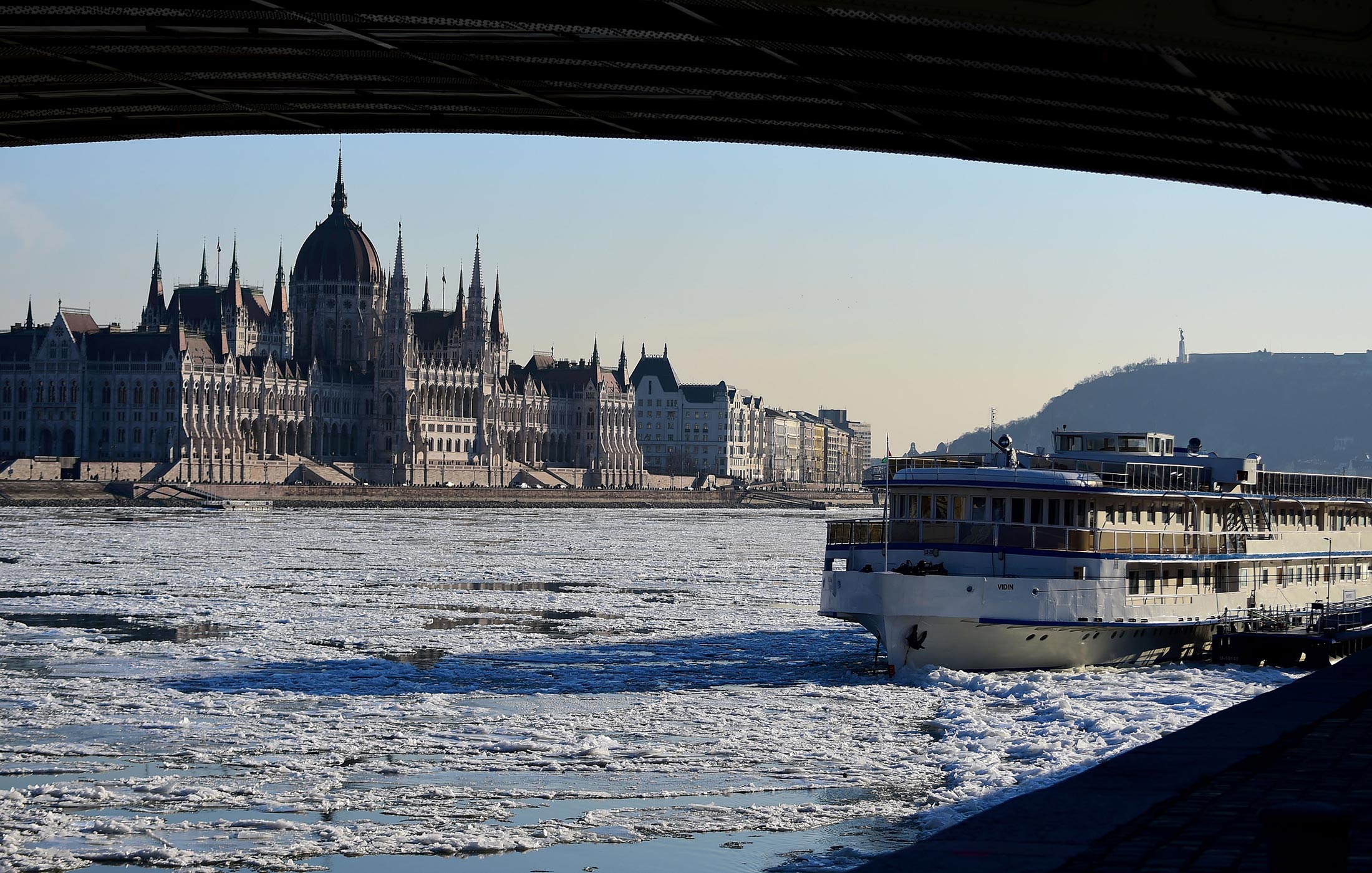 Ice floats in the water of the River Danube in front of the parliament building of Budapest downtown on January 8, 2017.
