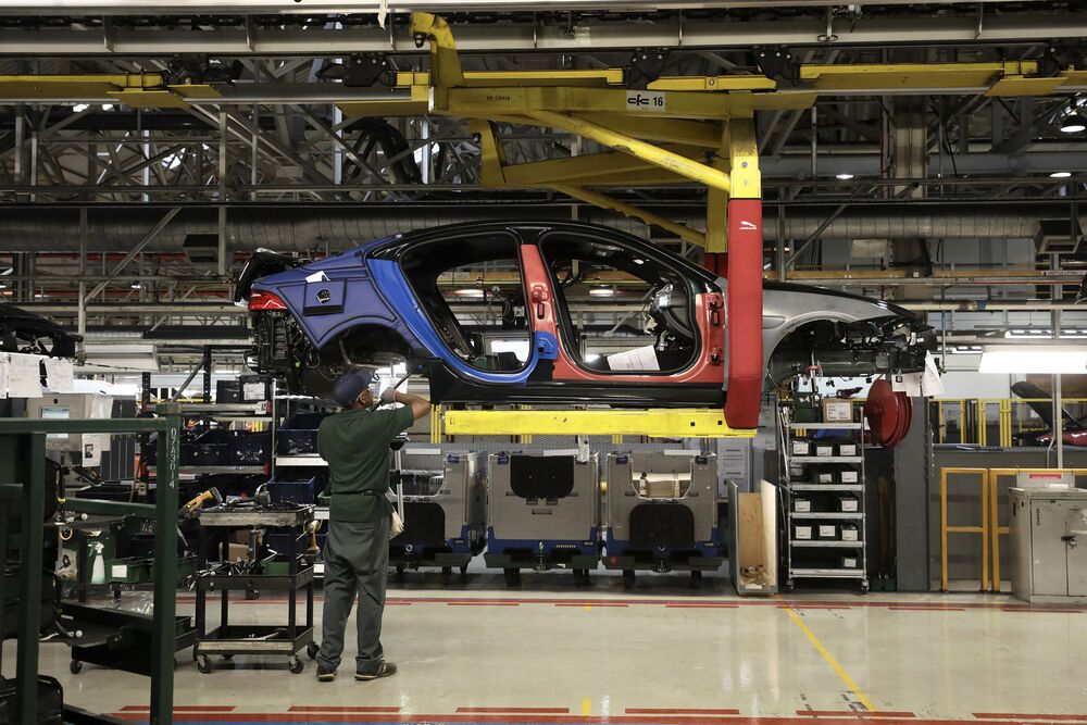 An employee works on a Jaguar XJ automobile on the production line at Tata Motors Ltd.'s Jaguar assembly plant in Castle Bromwich, U.K.