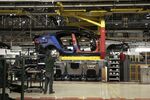 An employee works on a Jaguar XJ automobile on the production line at Tata Motors Ltd.'s Jaguar assembly plant in Castle Bromwich, U.K.