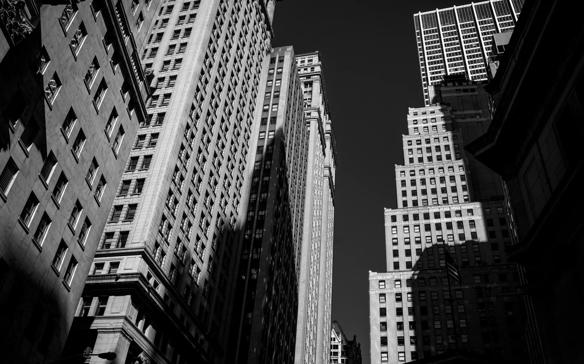The shadow of a building is seen here on other buildings on Wall Street near the New York Stock Exchange.
