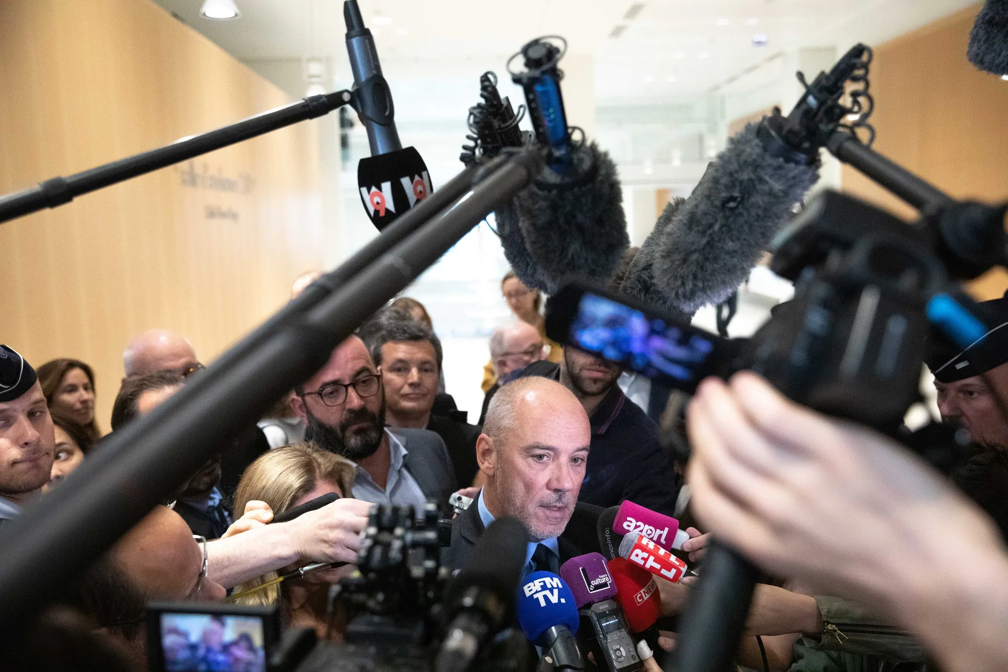 Stephane Richard speaks to television crews and journalists as he departs the Porte de Clichy courthouse in Paris, on July 9.